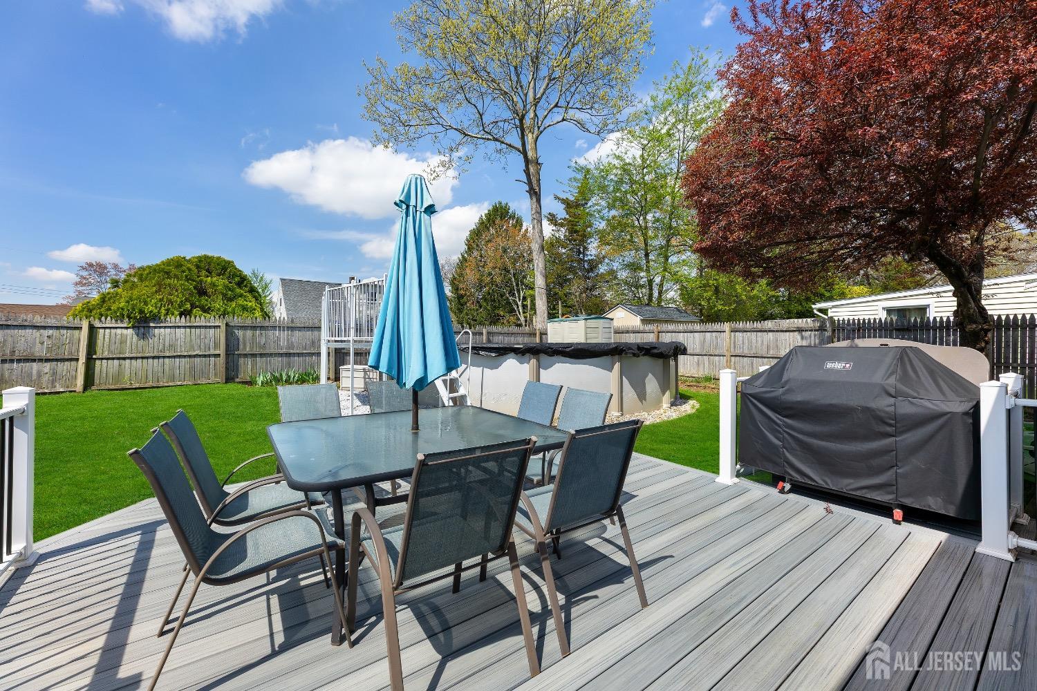 9 Pine Tree Road Old Bridge, NJ 08857 - Photo 9 of 46 a view of a patio with table and chairs and wooden floor