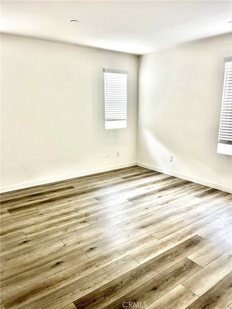 4255 Vermillion Court Riverside, CA 92505 - Photo 15 of 20 an empty room with wooden floor and windows