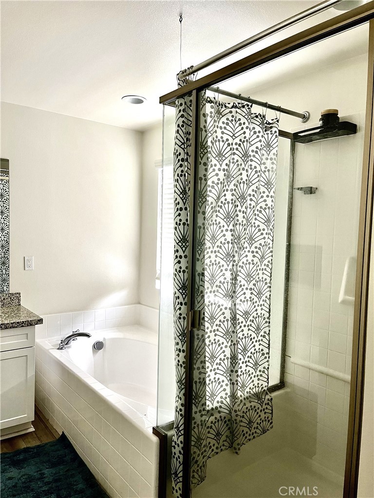 4255 Vermillion Court Riverside, CA 92505 - Photo 17 of 20 a bathroom with a shower and a bathtub