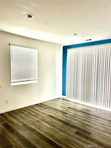 a kitchen with granite countertop white cabinets and stainless steel appliances