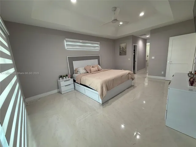 a spacious bedroom with a bed and a large mirror