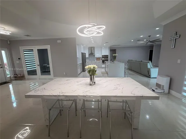 a kitchen with kitchen island stainless steel appliances sink cabinets and stove