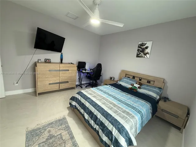 a bedroom with bed and tv