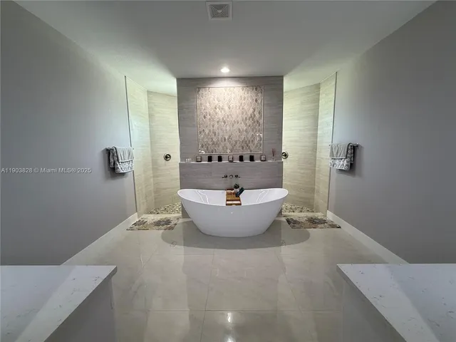 a large tub sitting in a bathroom
