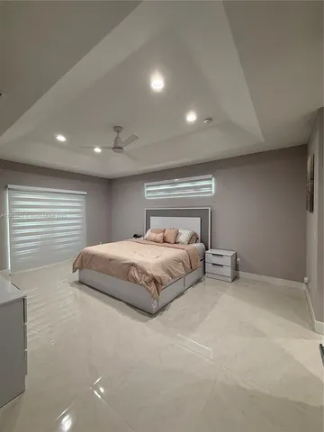 a spacious bedroom with a bed and a window