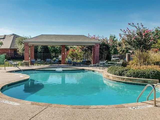 a view of a swimming pool with a patio