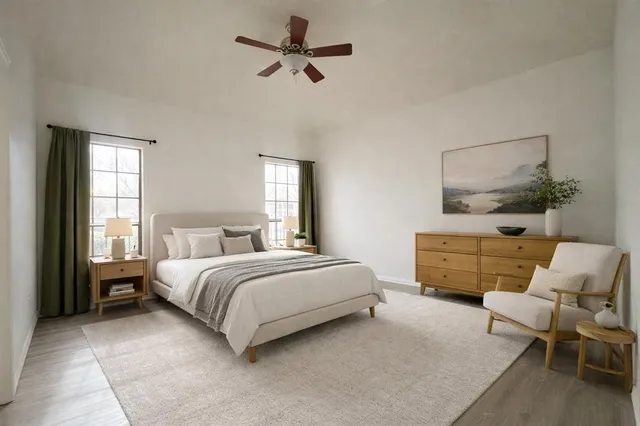 a bedroom with a bed a couch and window