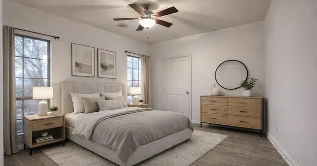 a bedroom with a bed a closet and large mirror