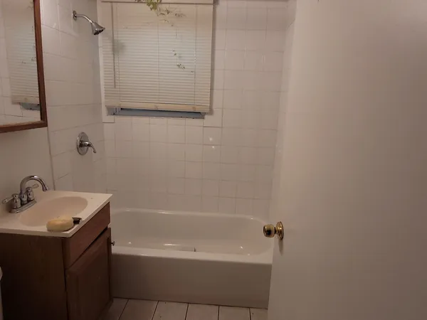 a bathroom with a bathtub and a sink