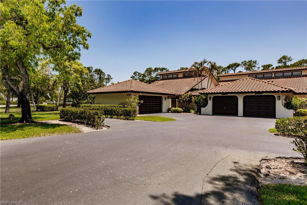 2118 Buckingham Lane Naples, FL 34112 - Photo 1 of 41 a front view of a house with a yard and garage