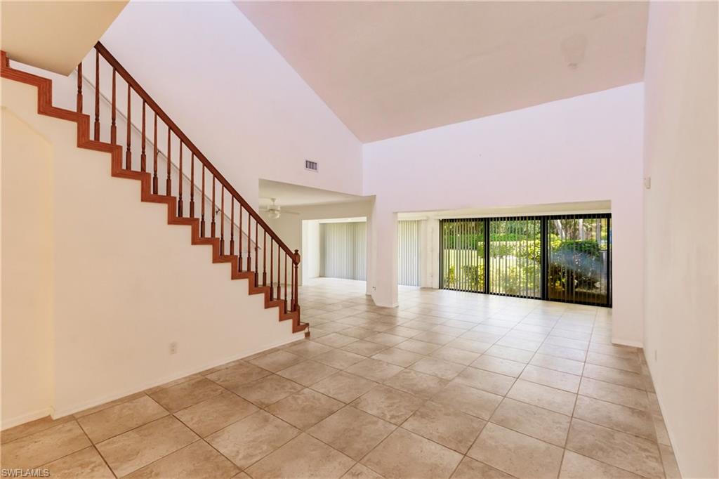 2118 Buckingham Lane Naples, FL 34112 - Photo 13 of 41 a view of entryway and hall with wooden floor