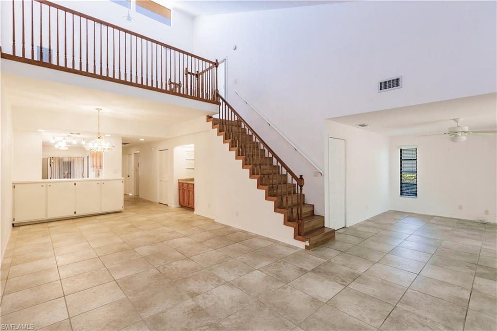 2118 Buckingham Lane Naples, FL 34112 - Photo 14 of 41 a view of a hallway with staircase