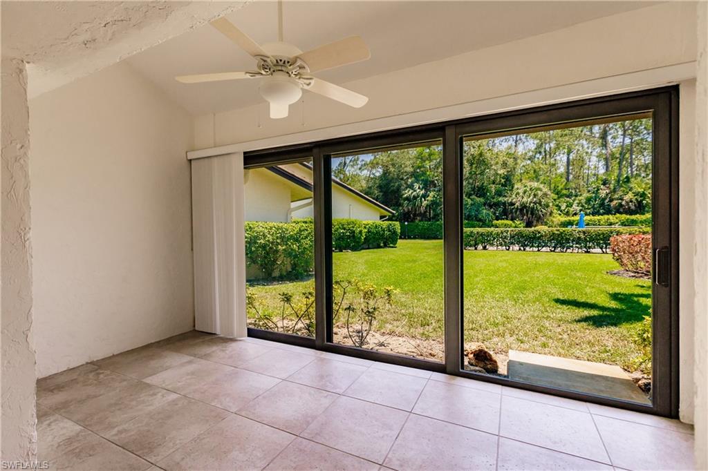 2118 Buckingham Lane Naples, FL 34112 - Photo 16 of 41 a view of an empty room with a large window with swimming pool view