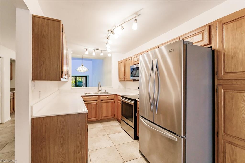 2118 Buckingham Lane Naples, FL 34112 - Photo 19 of 41 a kitchen with stainless steel appliances granite countertop a refrigerator and a sink