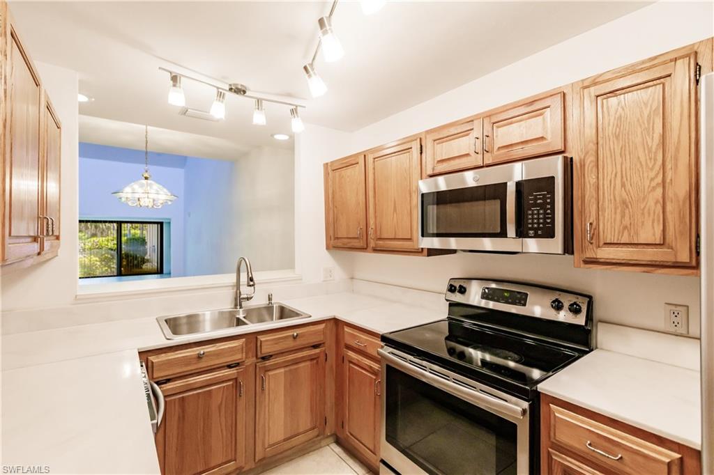 2118 Buckingham Lane Naples, FL 34112 - Photo 20 of 41 a kitchen with a sink and stainless steel appliances