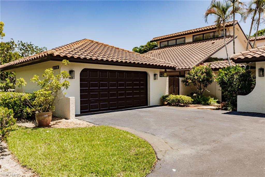 2118 Buckingham Lane Naples, FL 34112 - Photo 2 of 41 a front view of a house with a yard and garage