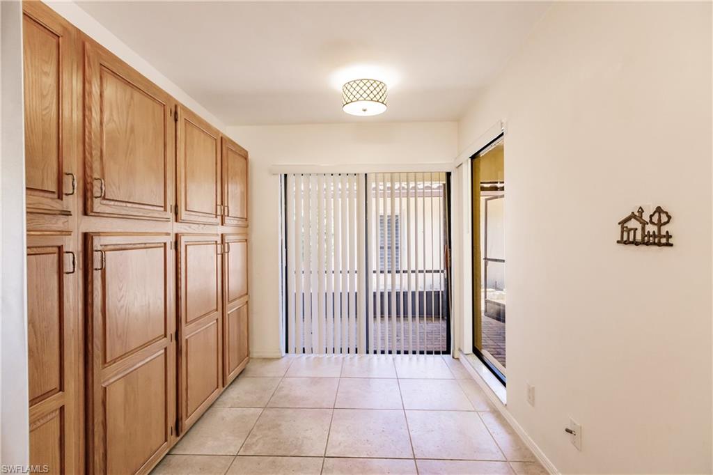 2118 Buckingham Lane Naples, FL 34112 - Photo 21 of 41 a view of a hallway with wooden floor and staircase