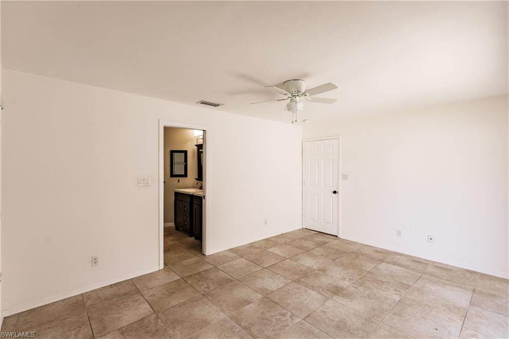 2118 Buckingham Lane Naples, FL 34112 - Photo 24 of 41 an empty room with a ceiling fan and a window