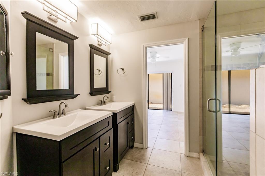 2118 Buckingham Lane Naples, FL 34112 - Photo 25 of 41 a bathroom with a sink and a mirror