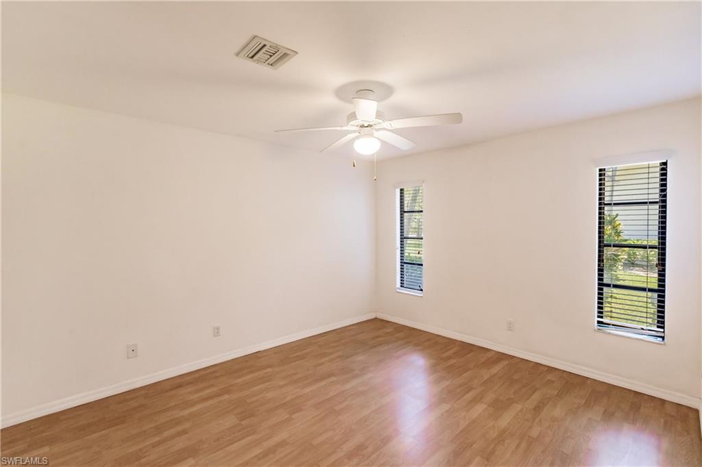 2118 Buckingham Lane Naples, FL 34112 - Photo 29 of 41 wooden floor in an empty room with a window