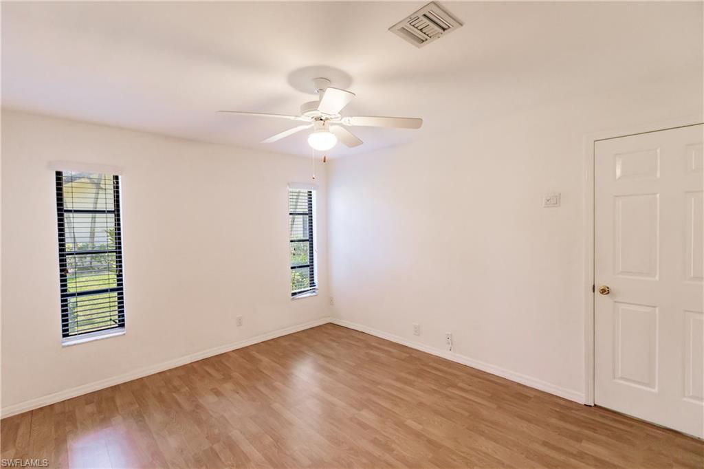 2118 Buckingham Lane Naples, FL 34112 - Photo 30 of 41 wooden floor in an empty room with a window