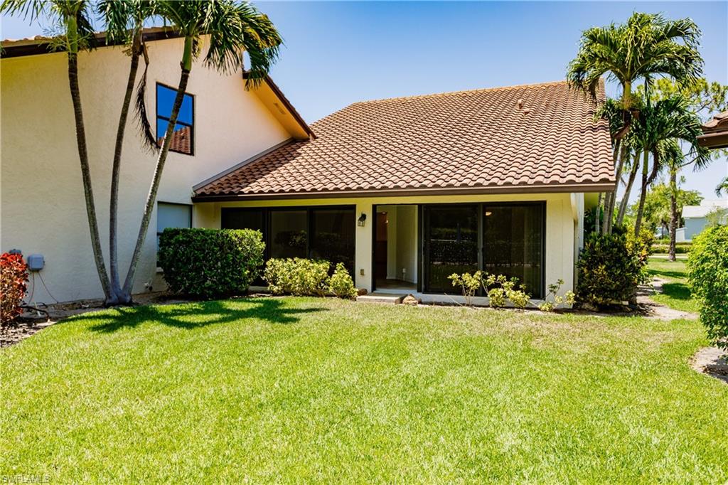 2118 Buckingham Lane Naples, FL 34112 - Photo 39 of 41 a front view of a house with swimming pool and porch with furniture