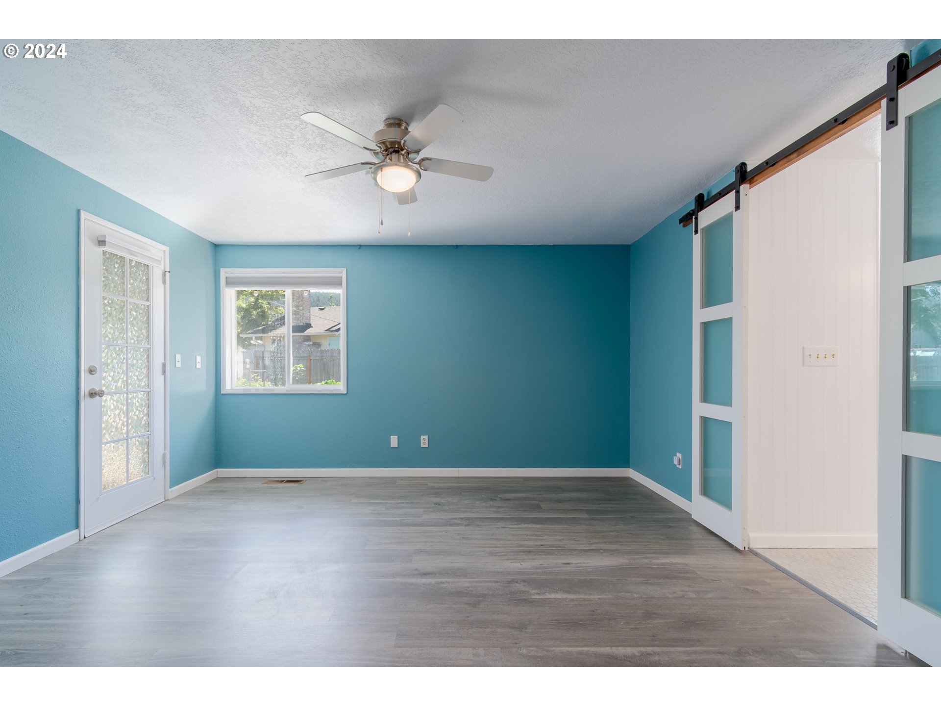 7345 B Street Springfield, OR 97478 - Photo 17 of 48 a view of an empty room with wooden floor and a window