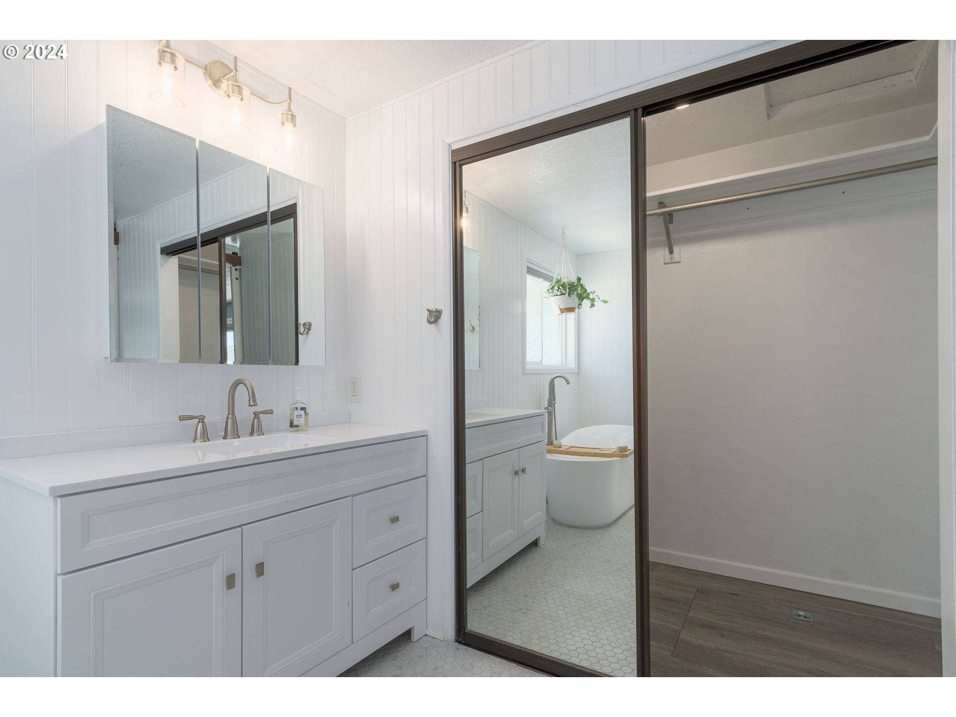 7345 B Street Springfield, OR 97478 - Photo 23 of 48 a bathroom with a toilet a sink a mirror and a shower