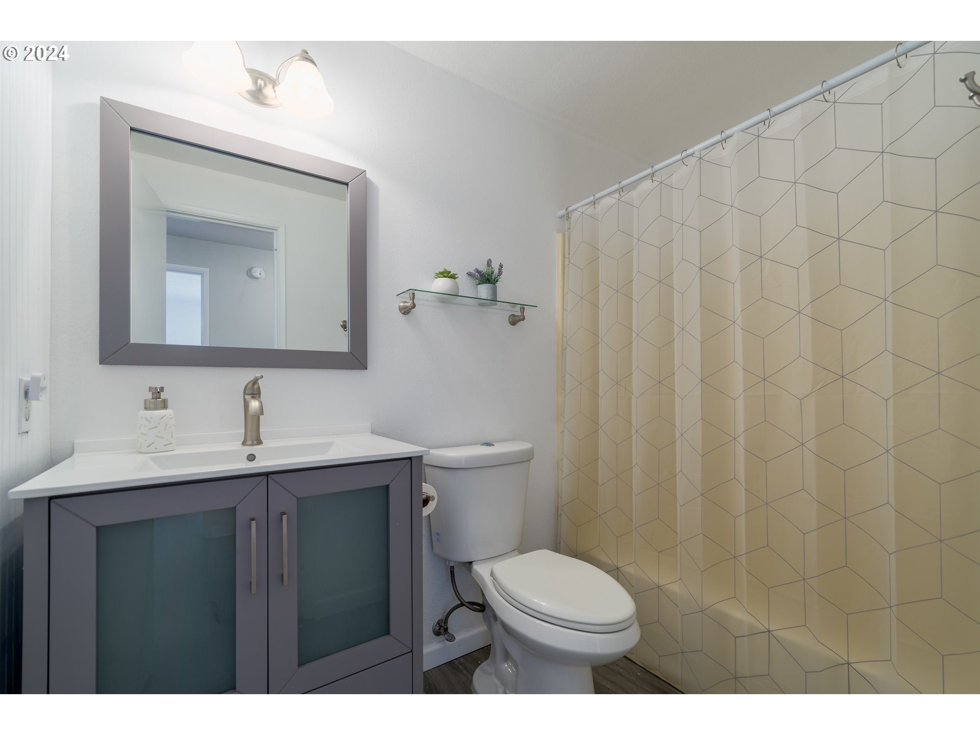 7345 B Street Springfield, OR 97478 - Photo 29 of 48 a bathroom with a toilet a sink and mirror