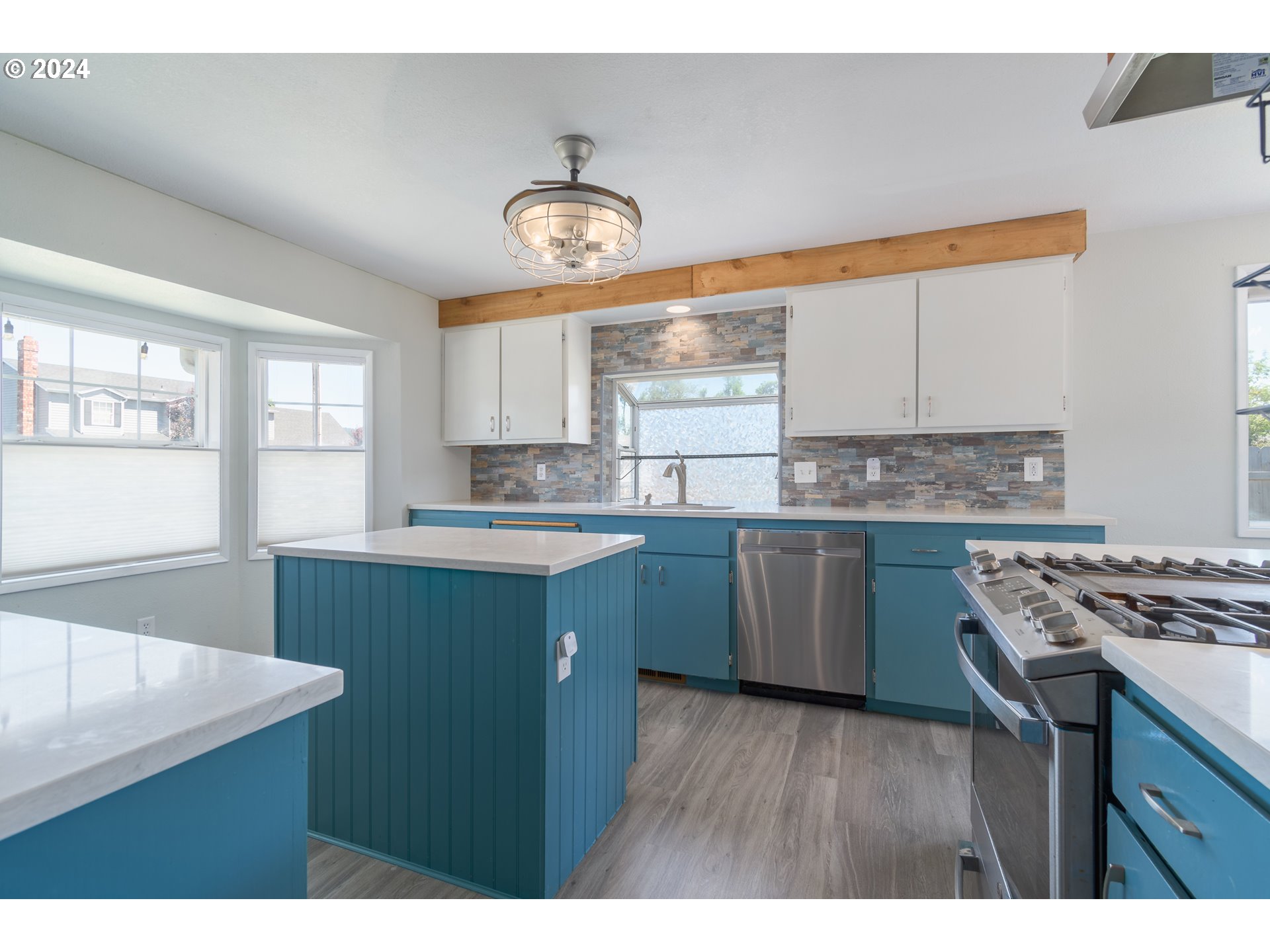 7345 B Street Springfield, OR 97478 - Photo 9 of 48 a kitchen with stainless steel appliances granite countertop a sink a stove a refrigerator cabinets and a window