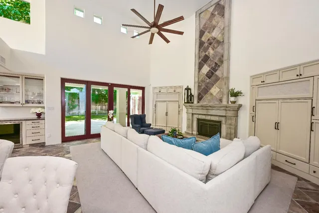 a large white kitchen with a large window and stainless steel appliances