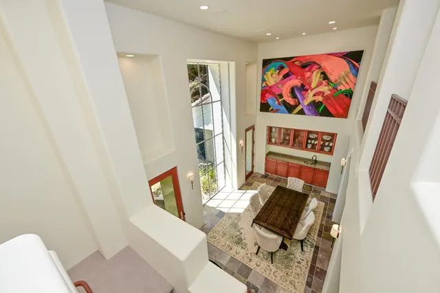 a view of a hallway with wooden floor and a bathroom