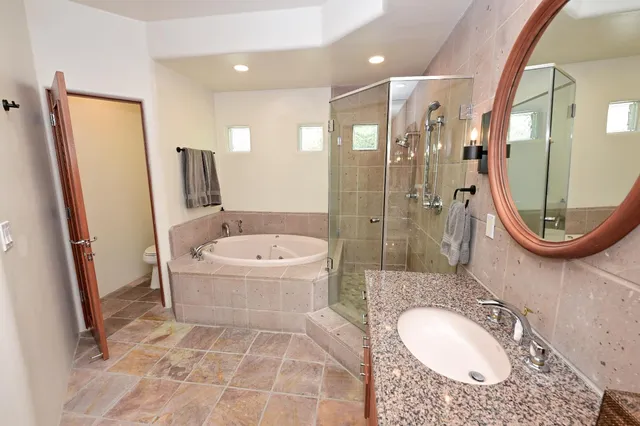 a bathroom with a sink a mirror and a shower