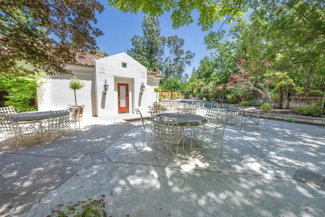 a front view of a house with a yard and potted plants