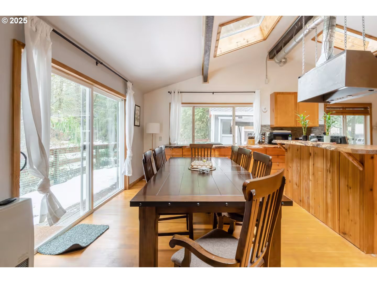71010 Mc Farland Road Rhododendron, OR 97049 - Photo 12 of 34 a dining room with furniture and a floor to ceiling window