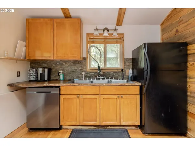 a kitchen with stainless steel appliances granite countertop a refrigerator and a stove