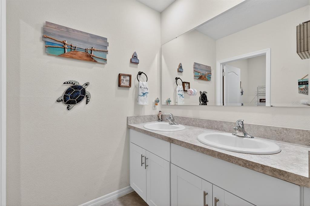 1809 Myrtlebrooke Drive Edgewater, FL 32141 - Photo 32 of 58 a bathroom with a granite countertop sink and a mirror