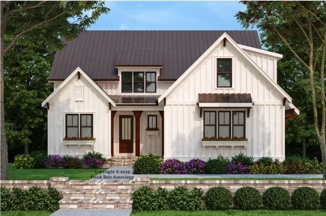 a view of white house with a yard and potted plants