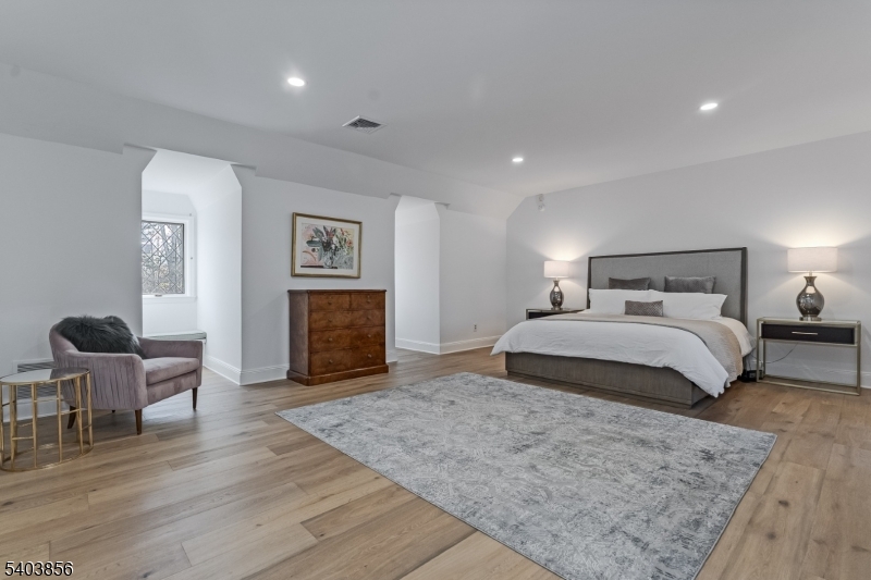 101 Sunny Branch Road Far Hills, NJ 07931 - Photo 18 of 35 a bedroom with a bed and chair