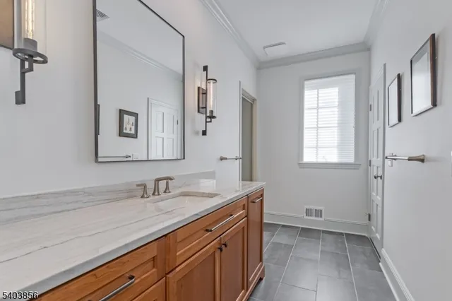 a spacious bedroom with a bed and wooden floor