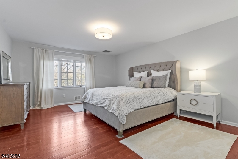 101 Sunny Branch Road Far Hills, NJ 07931 - Photo 22 of 35 a spacious bedroom with a bed and a night stand