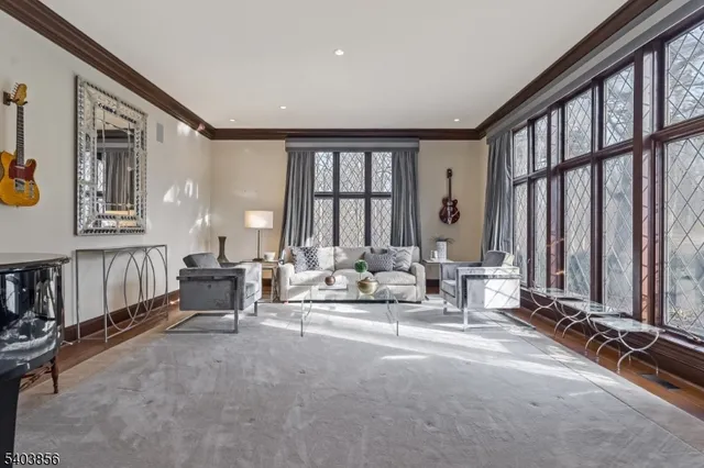 a living room with furniture and large windows