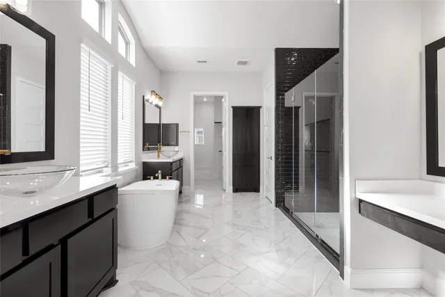 a large bathroom with a double vanity sink a large mirror and a shower