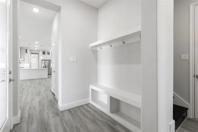 a view of walk in closet with wooden floor