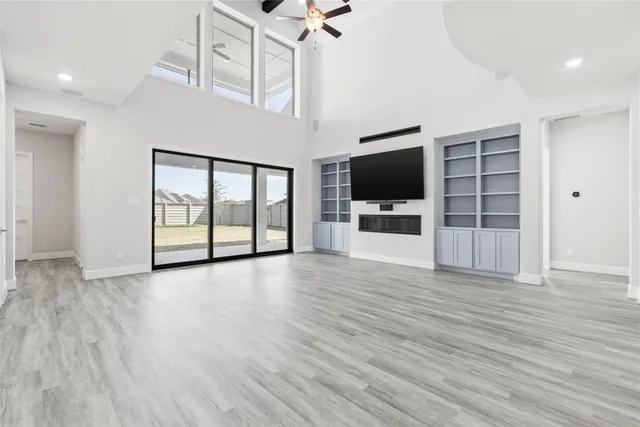 a view of a livingroom with furniture flat screen tv and wooden floor