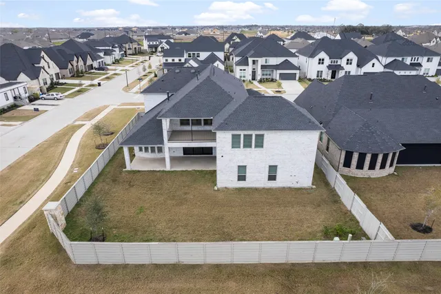 an aerial view of residential houses with outdoor space