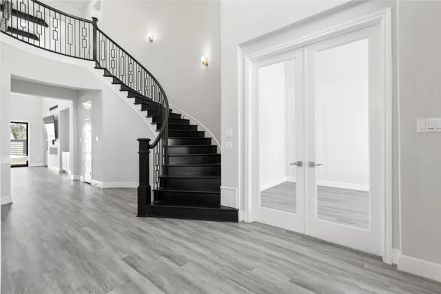 a view of entryway and hall with wooden floor