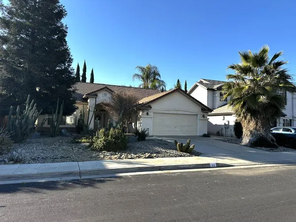 a view of a house with a yard and tree s