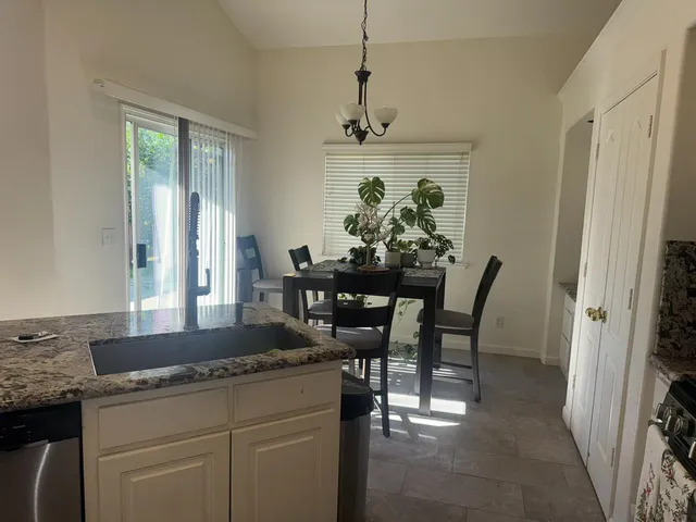 a view of a dining room with furniture and window