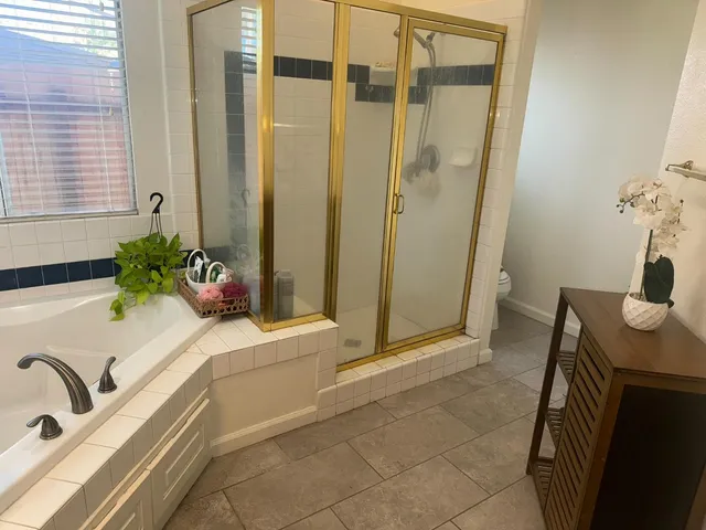 a bathroom with a tub sink and mirror